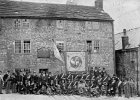 084  Army reservists (?) outside the Queens Head. The name over the door says James Gyte. Phil Tomlinson from Derby has emailed to say &#34;Just been looking at your web page as part of my family history and was amazed to find a picture of my Great Grandfather James Gyte. He was indeed listed as being the &#39;Inn Keeper&#39; at the Queens Head in the 1901 Census. This is the only know picture of him, (the tall gentleman in the doorway) also we are fairly confident the old gentleman standing to the right of him is his father Abraham Gyte and one of the ladies in the upstairs window we suspect will be his wife Elizabeth (Nee Mosley) If anyone else is researching their family history I would be pleased to hear from you if you have any of the following names in your tree - Tomlinson, Mosley or Gyte. Keep up the tremendous work. (You can contact Phil via  our contact page.